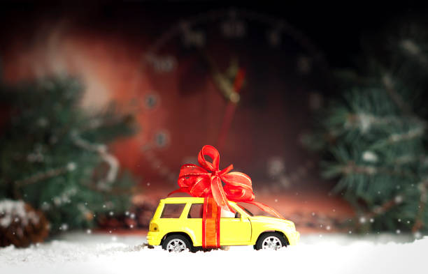 istock small car with a decorative bow in snow 860932080