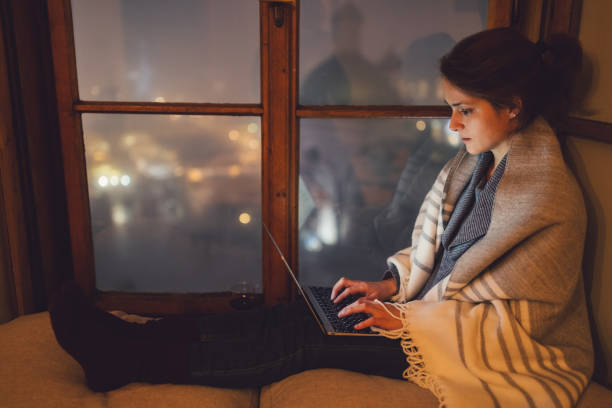 istock Woman wrapped in a blanket studying on lap top 860932126