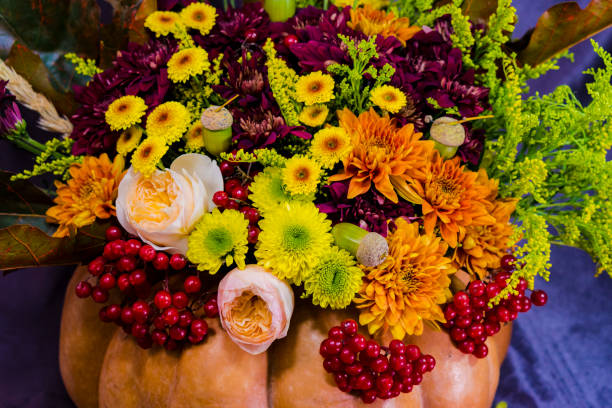 Bouquet for Halloween in a vase from pumpkin.