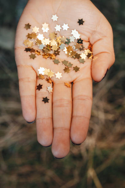 istock Girl holding gold star confetti 860939614