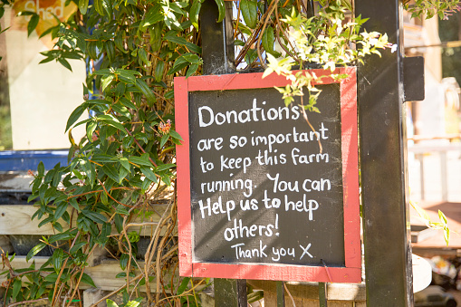 Image of a sign asking for donations at a farm.