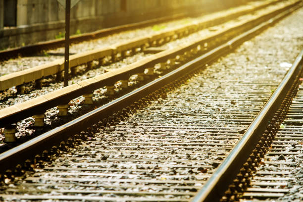 istock Railroad tracks in perspective with sunlight against 860954452