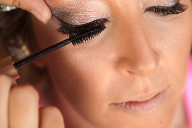 istock A woman in applying mascara 860954554