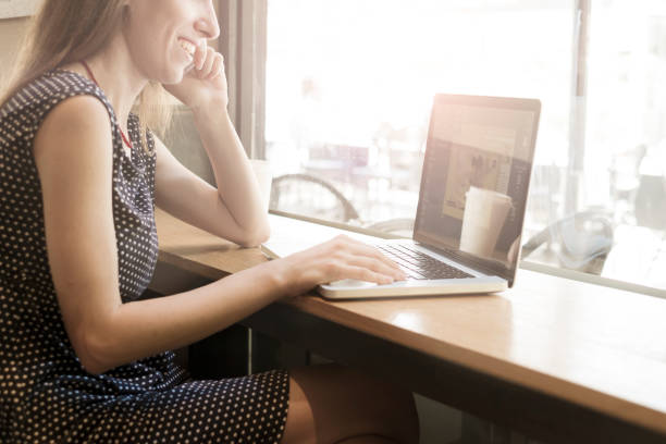 istock Woman working on laptop in a cafe 860958112