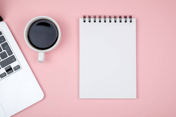 istock Minimal working desk with laptop and blank notepad page. Top view, flat lay and copy space 860958268