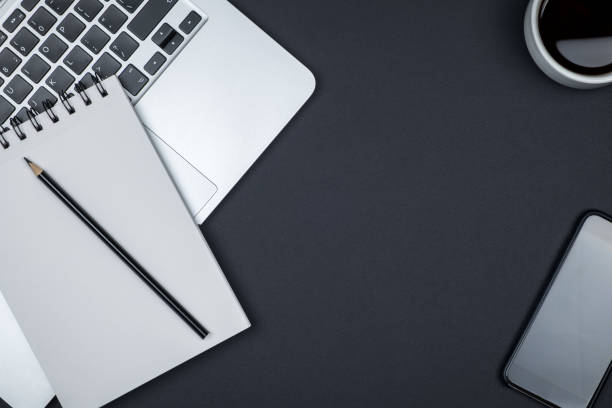 istock Modern designer office desk table with blank notebook page, laptop computer and cup of coffee. Top view, flat lay 860958346