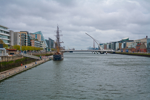 River Liffey with Samuel Beckett Bridge and Jeanie Johnston Tall Ship in Dublin, Ireland