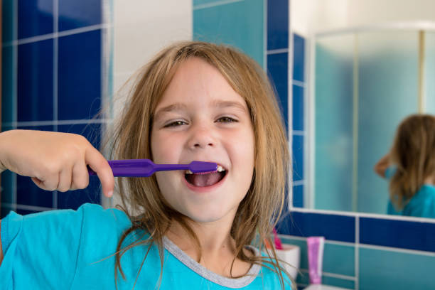 istock A little girl in the bathroom brushing her teeth. 860962074