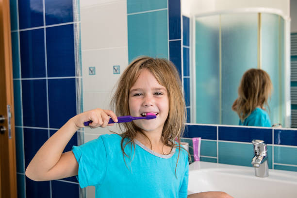 istock A little girl in the bathroom brushing her teeth. 860962204