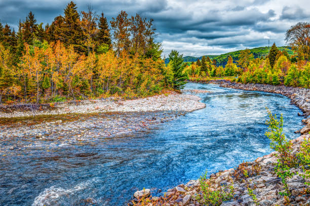 petit rio saguenay, quebec, canadá durante o outono com curva com folhagem laranja e azul água - saguenay - fotografias e filmes do acervo