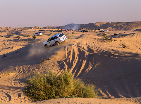Safari rally off-road car 4x4 Toyota adventure driving in the desert sand dune is a popular activity among tourists in Dubai.