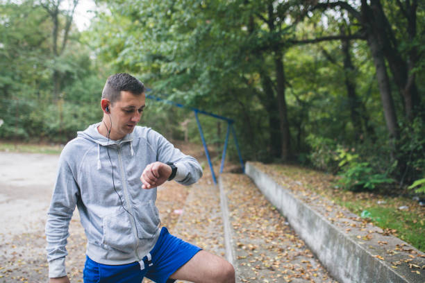 istock Athlete runner adjusting his GPS watch before a run. Close up. 860969470