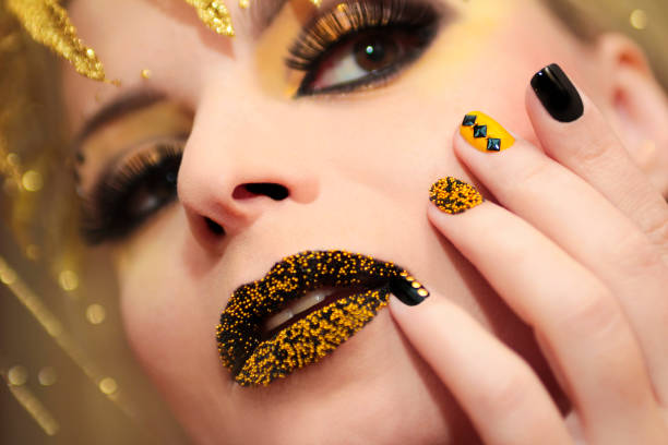 istock Yellow black manicure and makeup. 860969664