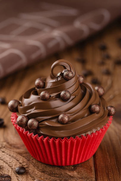istock Homemade coffee and chocolate cupcake in red cup 860973252