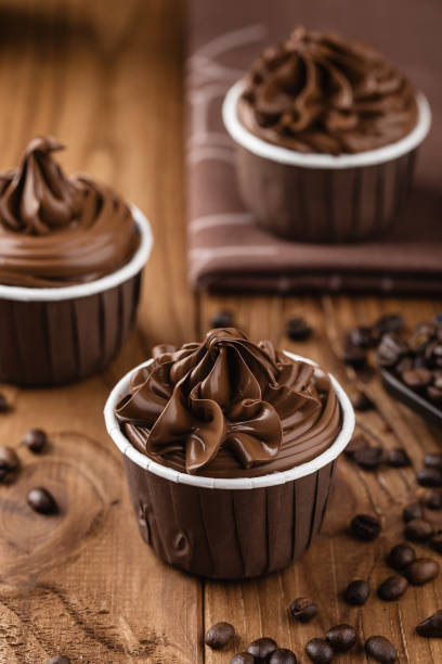 istock Homemade chocolate cupcakes on wooden background 860973272