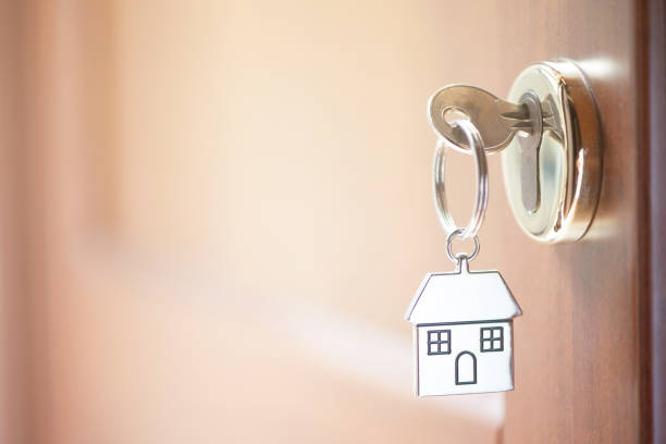 istock A key in a lock with house shape on it 860973772