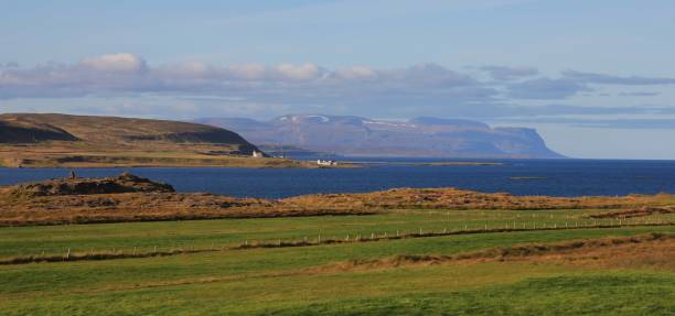 istock Green meadow and blue Atlantic ocean. Scene in north Iceland. 860979954