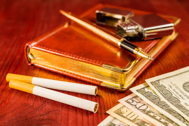 istock Money with a leather diary and cigarettes with golden pen 860980344