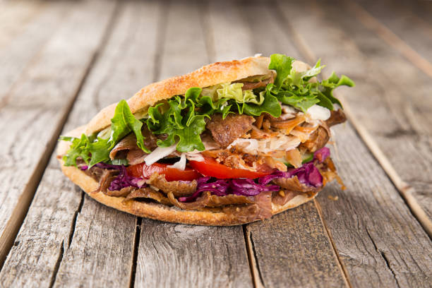 Close up of kebab sandwich close up of kebab sandwich on wooden background kebab pita stock pictures, royalty-free photos & images
