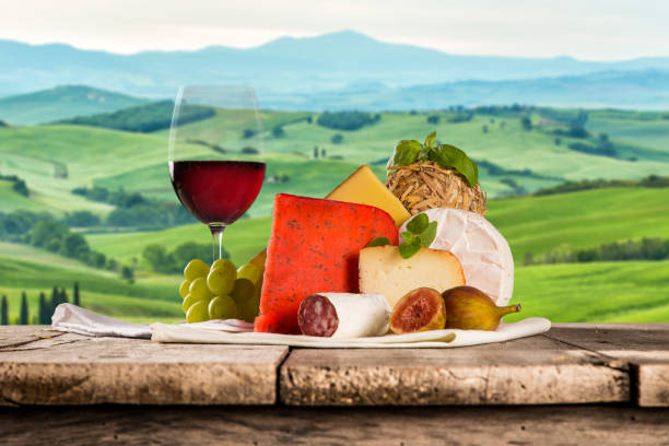 istock Delicious cheeses with wine on old wooden table 860990436