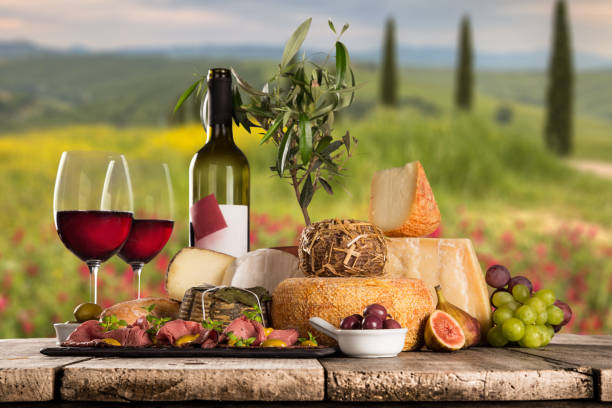 istock Delicious cheeses with wine on old wooden table 860990486