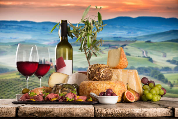 istock Delicious cheeses with wine on old wooden table 860990508