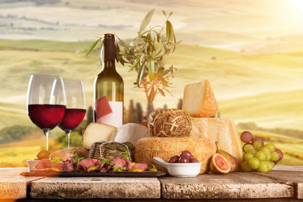 istock Delicious cheeses with wine on old wooden table 860990798