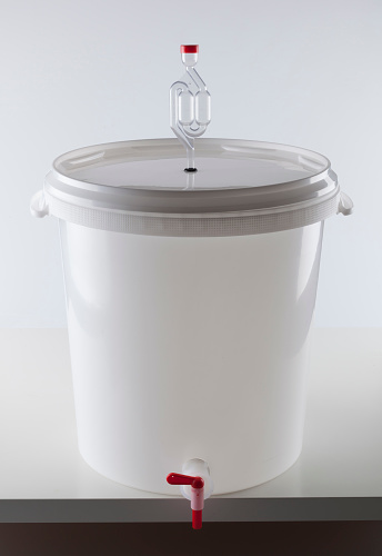Home beer brewing fermentation bucket with airlock