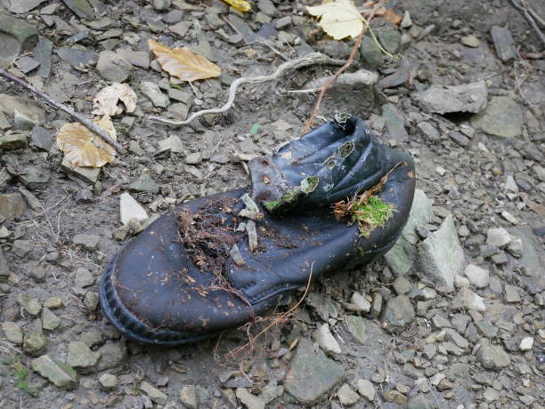 istock Old trekking boot on the trail. 860992738