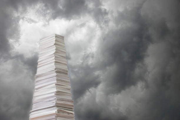 Stack of paper against a stormy sky