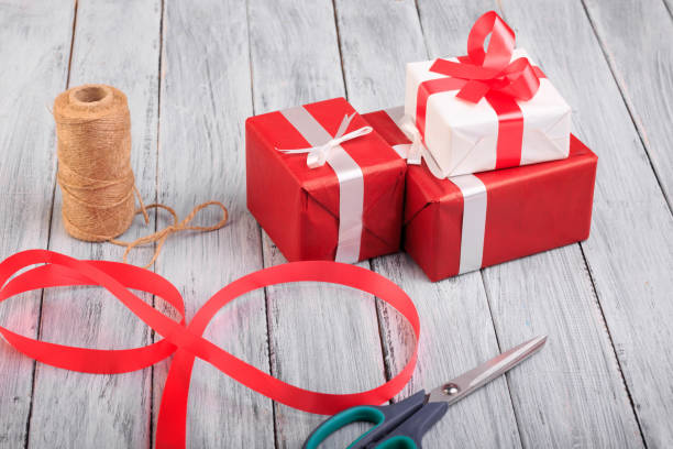 istock Beautiful gift boxes with a red and white bow on a wooden background. 860999264