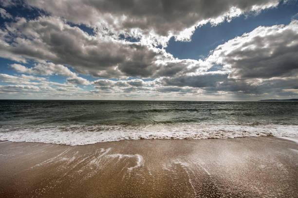 View of the sea surf under the contrasting blue cloudy sky