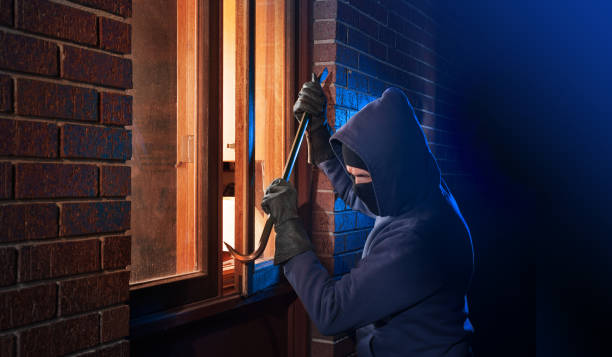 Burglar breaking into a home stock photo