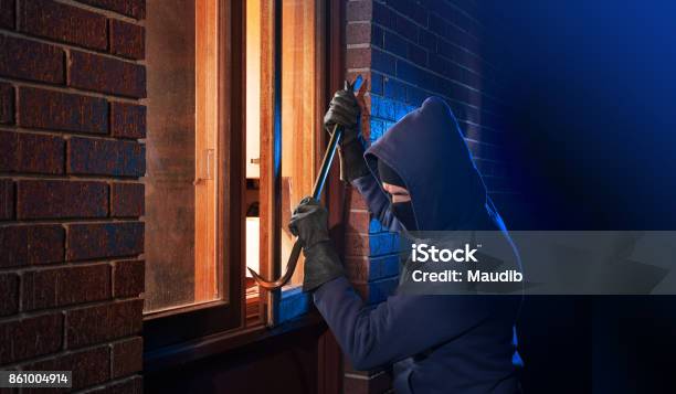 Burglar Breaking Into A Home Stock Photo - Download Image Now - Burglar, House, Thief