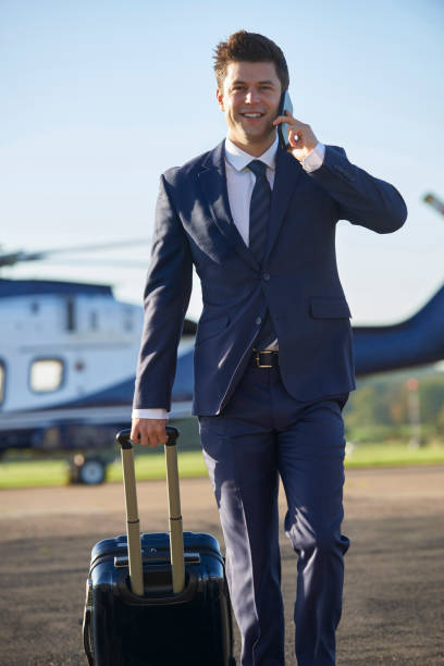istock Businessman Walking Away From Helicopter Whilst Talking On Mobile Phone 861012424