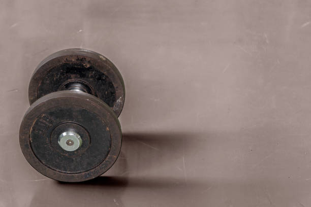istock Old dumbbell on floor, fitness concept 861012470