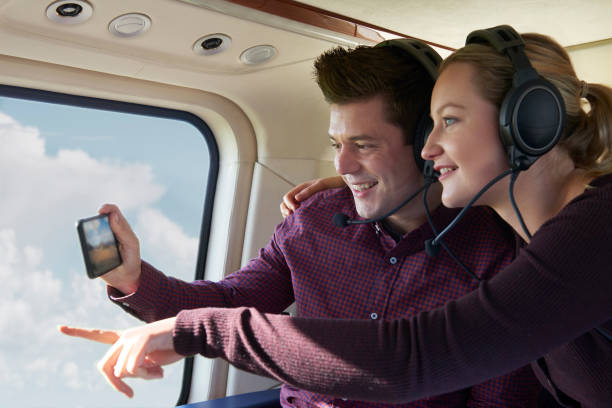 Couple On Vacation Taking Ride In Helicopter Couple On Vacation Taking Ride In Helicopter helicopter stock pictures, royalty-free photos & images