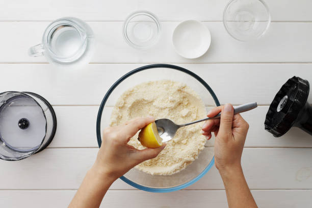 istock Step by step recipe galette or pie with nectarines. Female hands squeezing lemon into spoon for dough. 861012938