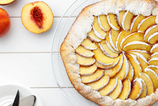 istock Homemade galette or pie with nectarines on white wooden table. 861012954