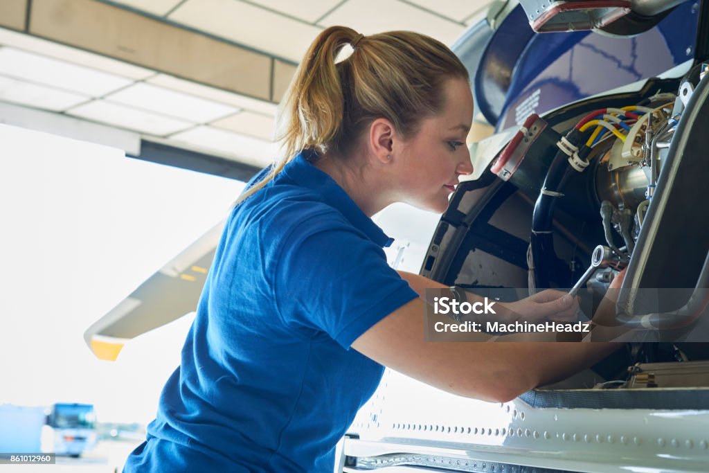 Female Aero Engineer Working On Helicopter In Hangar Air Vehicle Stock Photo