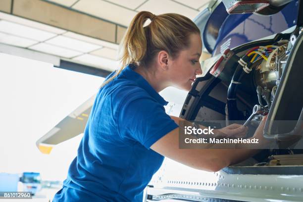 Female Aero Engineer Working On Helicopter In Hangar Stock Photo - Download Image Now