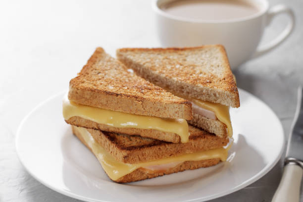 Grilled cheese sandwich of wholegrain bread with coffee for healthy breakfast. stock photo