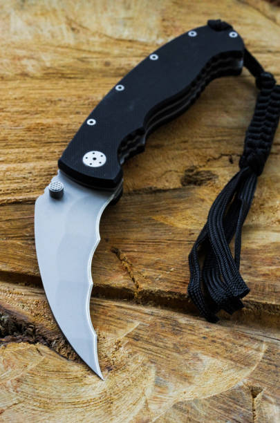 istock Knife for military and tactical tasks. Knife with a black strap. 861020382