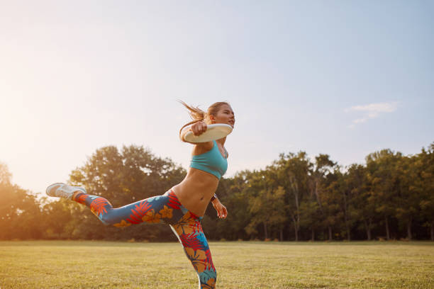 istock Young athletic girl playing with flying disc, ultimate 861020426