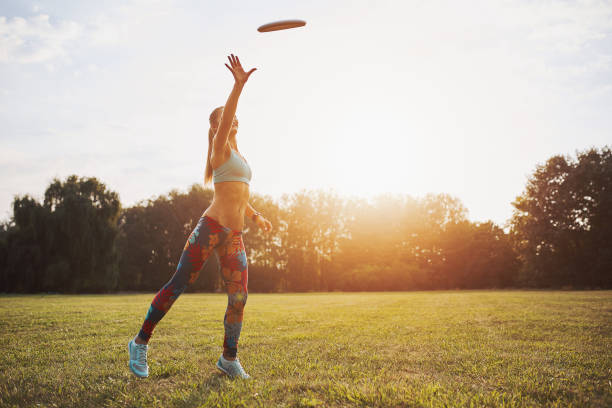istock Young athletic girl playing with flying disc, ultimate 861020570