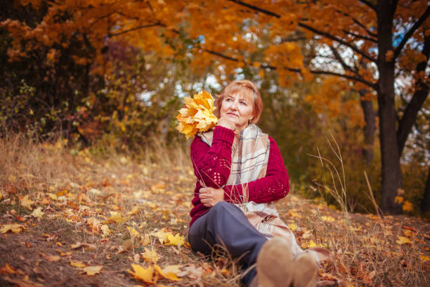 istock Middle-aged woman relaxes in autumn forest 861023078