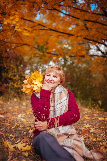 istock Middle-aged woman relaxes in autumn forest 861023108