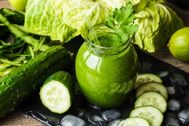 istock Detox diet. Green smoothie with different vegetables on wooden background 861026180
