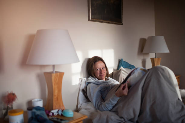 istock A woman reading a magazine in bed 861030178