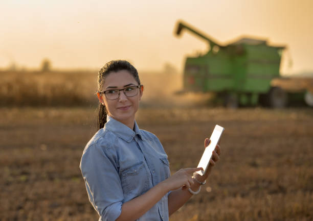 istock Agronomist with tablet in front of combine harvester 861030602
